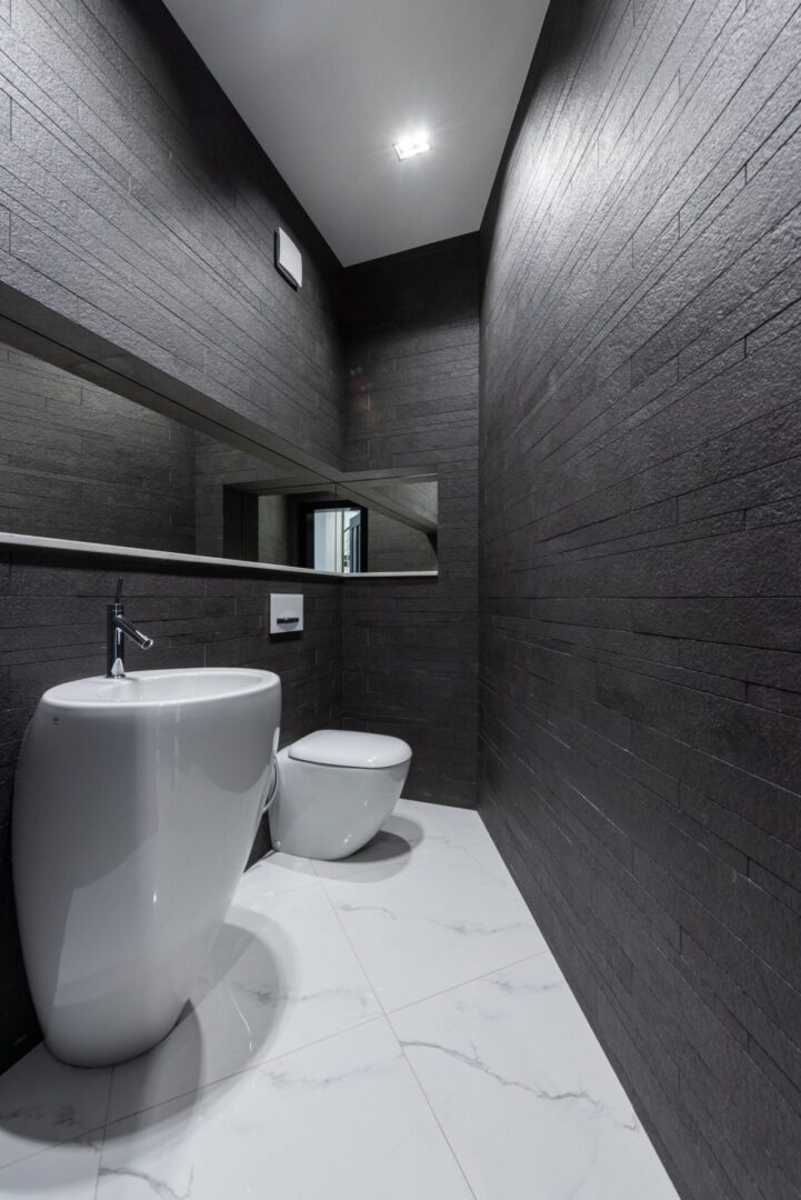 white marble floor with black walls in bathroom