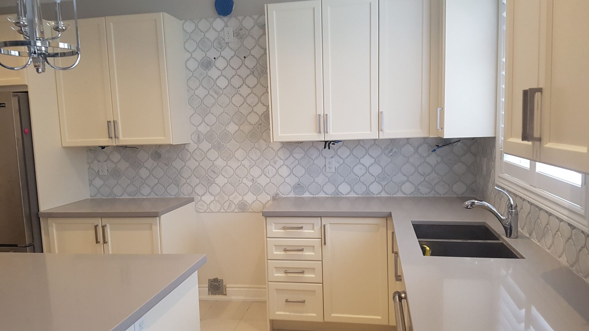 white and gray patterned wall and white cabinets